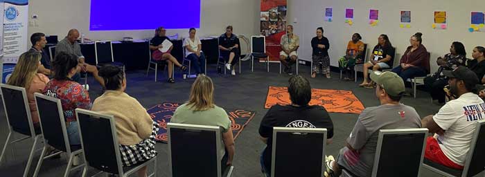 Attendees sitting in a circle during Leading Our Ways event